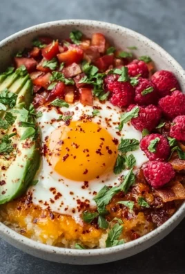Delicious high protein breakfast bowl with eggs, quinoa, and fresh vegetables