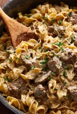 Delicious beef stroganoff served with noodles and garnished with parsley