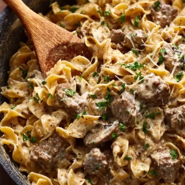Delicious beef stroganoff served with noodles and garnished with parsley