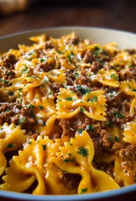 Cajun Cream Cheese Alfredo Bowties topped with spiced ground beef and herbs