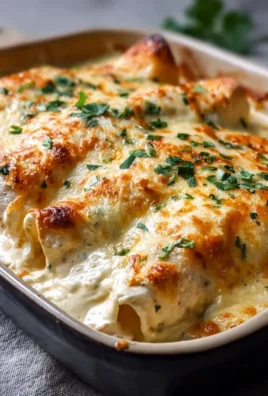 Delicious creamy white chicken enchiladas topped with cheese and cilantro