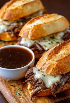 Crockpot French Dip Sandwiches with juicy beef, cheese, and rich au jus