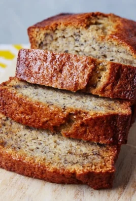 Moist homemade banana bread sliced and served on a plate