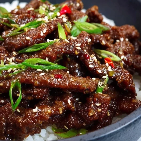 Delicious Easy Mongolian Beef served with steamed rice and vegetables.