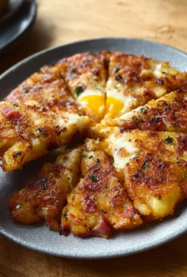 Delicious fried potato cheese hash served in a bowl with herbs.