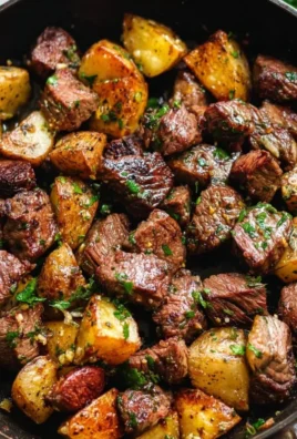 Delicious garlic butter steak bites served with crispy potatoes.