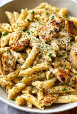 Creamy Garlic Parmesan Chicken Pasta served in a bowl with parsley garnish