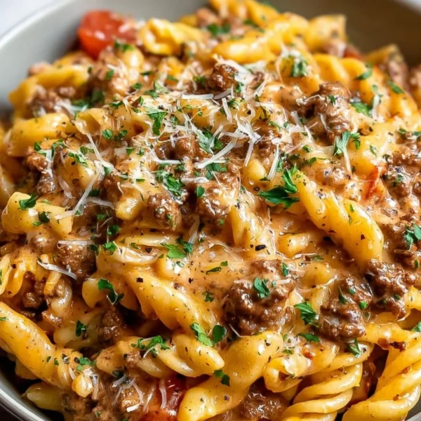 Creamy beef pasta dish garnished with herbs