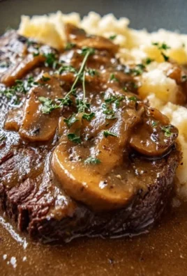 Instant Pot round steak cooked in gravy served on a plate with vegetables