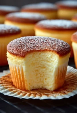 Fluffy Japanese cotton cheesecake cupcakes topped with cream and berries