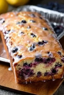 Delicious slice of lemon blueberry bread on a rustic wooden table