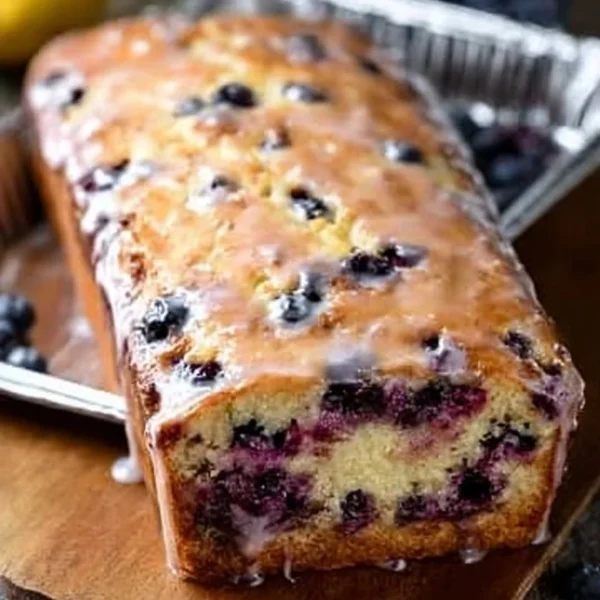 Delicious slice of lemon blueberry bread on a rustic wooden table
