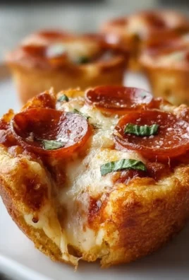 Mini deep dish crescent roll pizzas topped with cheese and pepperoni