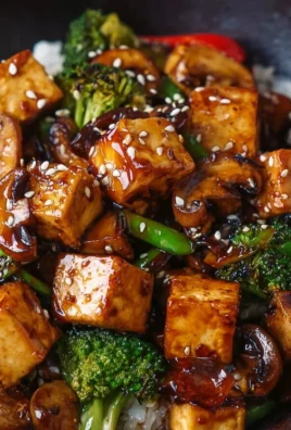 Colorful Mushroom and Tofu Stir-Fry in a bowl with fresh vegetables and herbs