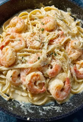 One pan shrimp fettuccine alfredo garnished with parsley