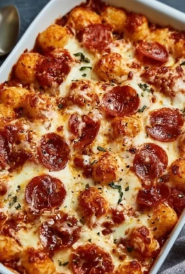Slice of Pizza Tot Casserole with melted cheese and toppings