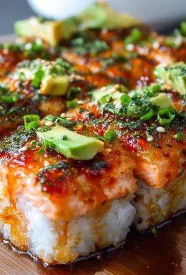 Spicy Salmon Sushi Bake dish prepared in a baking tray with garnishes.