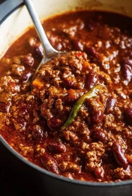 Delicious bowl of the best chili recipe topped with cheese and herbs