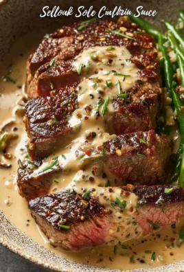 Delicious steak dinner with creamy garlic and peppercorn sauce on a plate