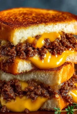 Ultimate Cheesy Ground Beef Melt served on a plate with melted cheese and toppings
