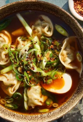 Delicious homemade Gyoza Soup served in a bowl with fresh ingredients