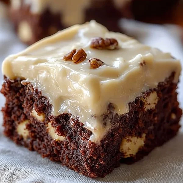 Delicious banana bread brownies topped with chocolate drizzle on a plate