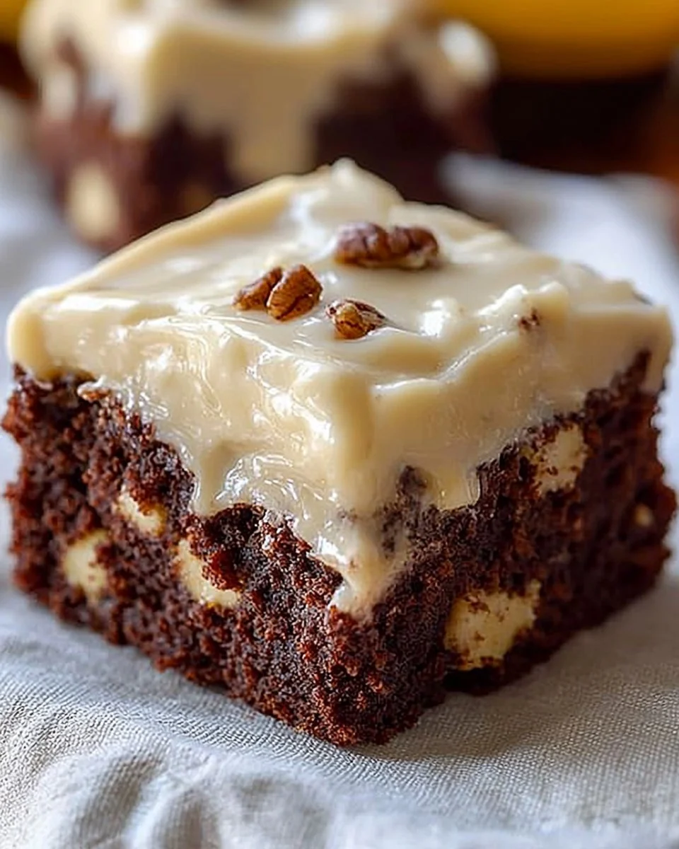 Delicious banana bread brownies topped with chocolate drizzle on a plate