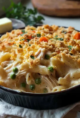 Creamy chicken pot pie pasta bake topped with golden breadcrumbs and herbs