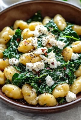 Creamy gnocchi with spinach and feta served on a plate