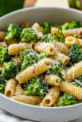 Healthy broccoli pasta dish with fresh vegetables and herbs