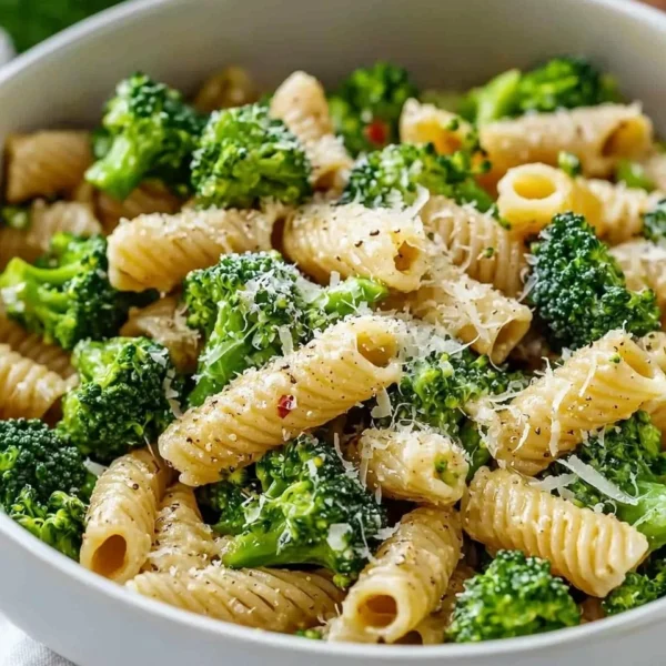 Healthy broccoli pasta dish with fresh vegetables and herbs