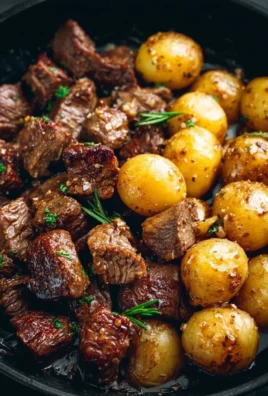 Garlic Butter Beef Bites served with crispy potatoes