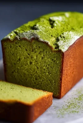 Sliced Japanese matcha pound cake on a plate with a cup of tea