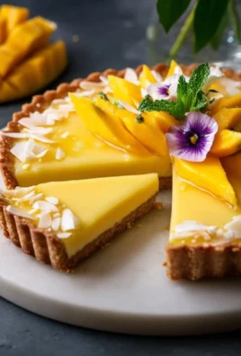 Deliciously creamy mango curd tart topped with ripe mango slices