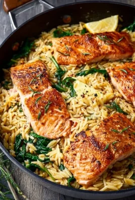 One skillet salmon served with lemon orzo on a plate