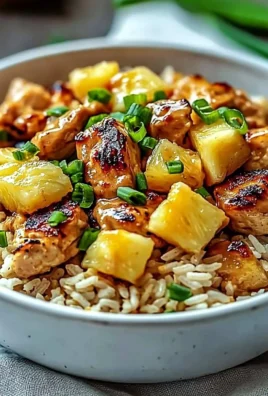 Delicious Pineapple Chicken served over rice with fresh pineapple chunks