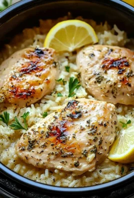 Slow cooker lemon herb chicken and rice served in a bowl with fresh herbs