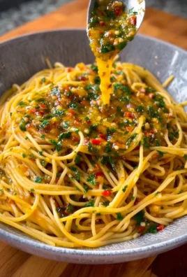 Plate of spaghetti with garlic and oil garnished with parsley