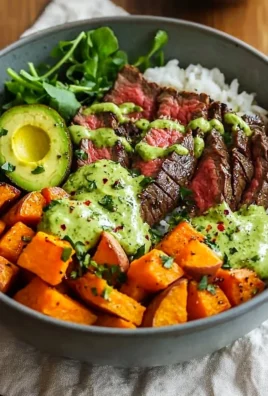 Steak and sweet potato bowls with avocado-cilantro drizzle on a plate