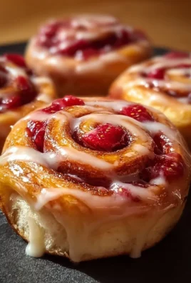 Delicious Strawberry Cheesecake Cinnabon Rolls with a creamy filling and strawberry topping