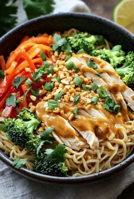 Delicious Thai Peanut Chicken Noodle Bowl with vibrant vegetables and noodles.